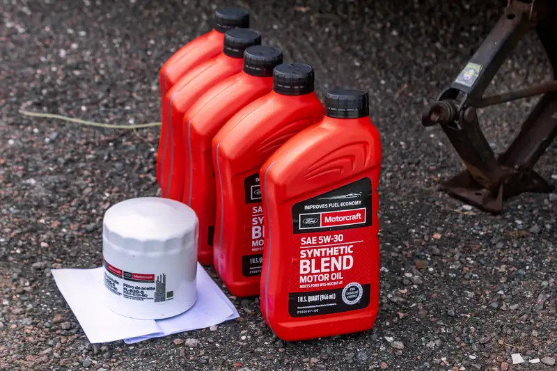 Bottles of synthetic blend motor oil beside a new oil filter